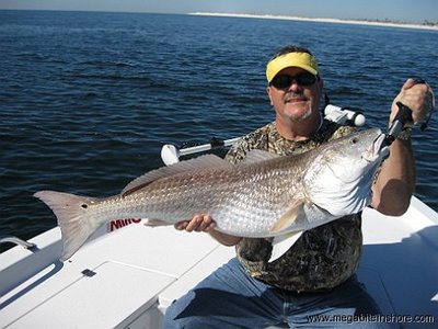 Jerry holds up his biggest red fish ever.