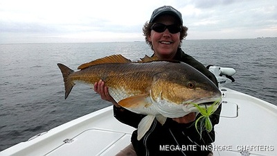 Laura is all smiles after landing this monster redfish.
