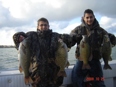 Happy Indiana smallmouth bass anglers display their smallmouth bass caught with Erie Quest Charters