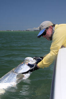 Capt. Rick Grassett with a tarpon he caught on a black Deceiver fly in Sarasota.