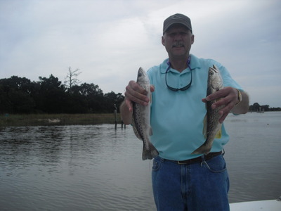Area visitor Kent Chancellor sahow off a nice Speckled Trout (right) & a Weakfish Trout.