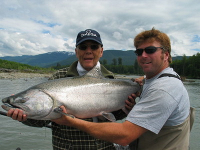 Tracey Hittel, owner of Kitimat Lodge, assisting his repeat guest Frank Aldo from Switzerland pose one of his BIG Kitimat River Chinook Salmon. He landed seven Chinook on this day.