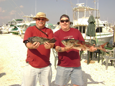 Two happy anglers with their varied catch.