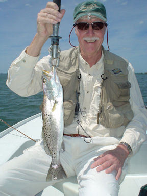 Dick Egan, from IL, with a slot-size trout caught and released on an Ultra Hair clouser fly while fishing Sarasota Bay with Capt. Rick Grassett.