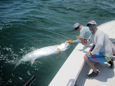 Jeb Mulock, from Bradenton, FL, with his first tarpon caught and released on a fly while fishing the coastal gulf in Sarasota with Capt. Rick Grassett.