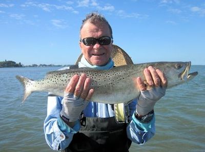 Nick Reding, from Longboat Key FL, with a big trout caught and released on a Grassett Flats Minnow fly while wading a Sarasota Bay sand bar with Capt. Rick Grassett.