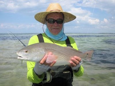 Nick Reding, from Longboat Key, FL, with a nice red caught and released on a Grassett Flats MInnow fly while fishing Tampa Bay with Capt. Rick Grassett.