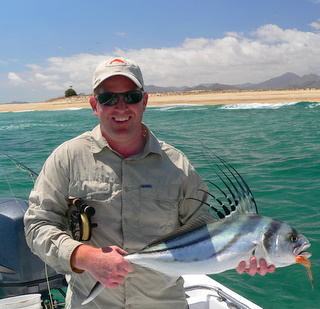 Jamie Clark showinf off his first rooster fish on a fly