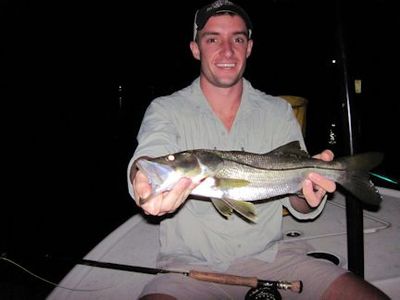 Will Travis, from Houston, TX, with a snook caught and released on a Grassett Snook Minnow fly while fishing lighted docks in Sarasota Bay with Capt. Rick Grassett.