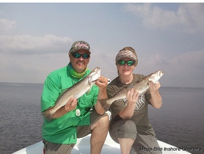 Capt. John & his wife Gina showing off two nice trout