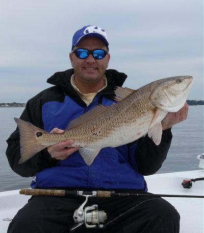 Capt. John show's off a nice slot red caught on a 3