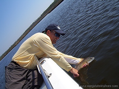 Releasing a redfish in Escambia Bay