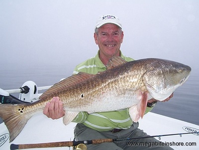 Joe with his first ever fish a big Redfish at 38