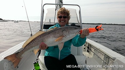 Karen is all smiles after landing this big redfish