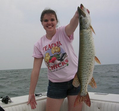Monica Davy proudly shows off her Lake Erie Musky caught aboard Erie Quest Charters