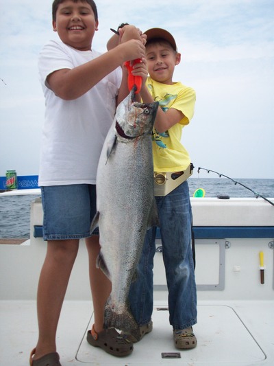 8 yr old eric with his first  lake ontario salmon, had to have his older brother help him hold it up.