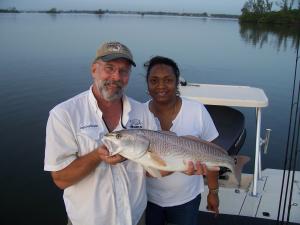 Capt Charlie holding Debra Johnson's 30