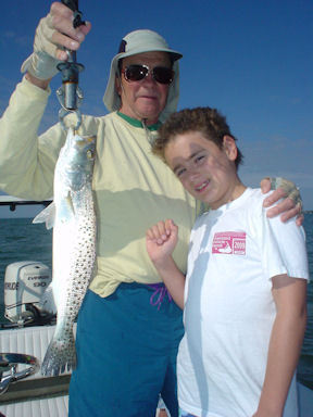 Sarasota winter resident, Nick Reding, and his grandson, Nicholas, with a nice trout caught on a DOA Deadly Combo while fishing Sarasota Bay with Capt. Rick Grassett.