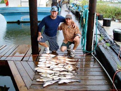 Happy fisherman with some nice reds and trout