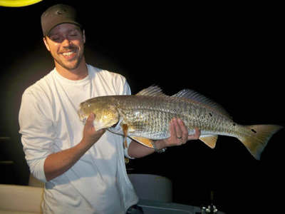 Client with a fish caught while night fishing with Capt.Bill