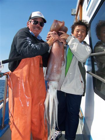 11 year old Oliver Dong caught his first, Deckhand Gary Christensen helps hold